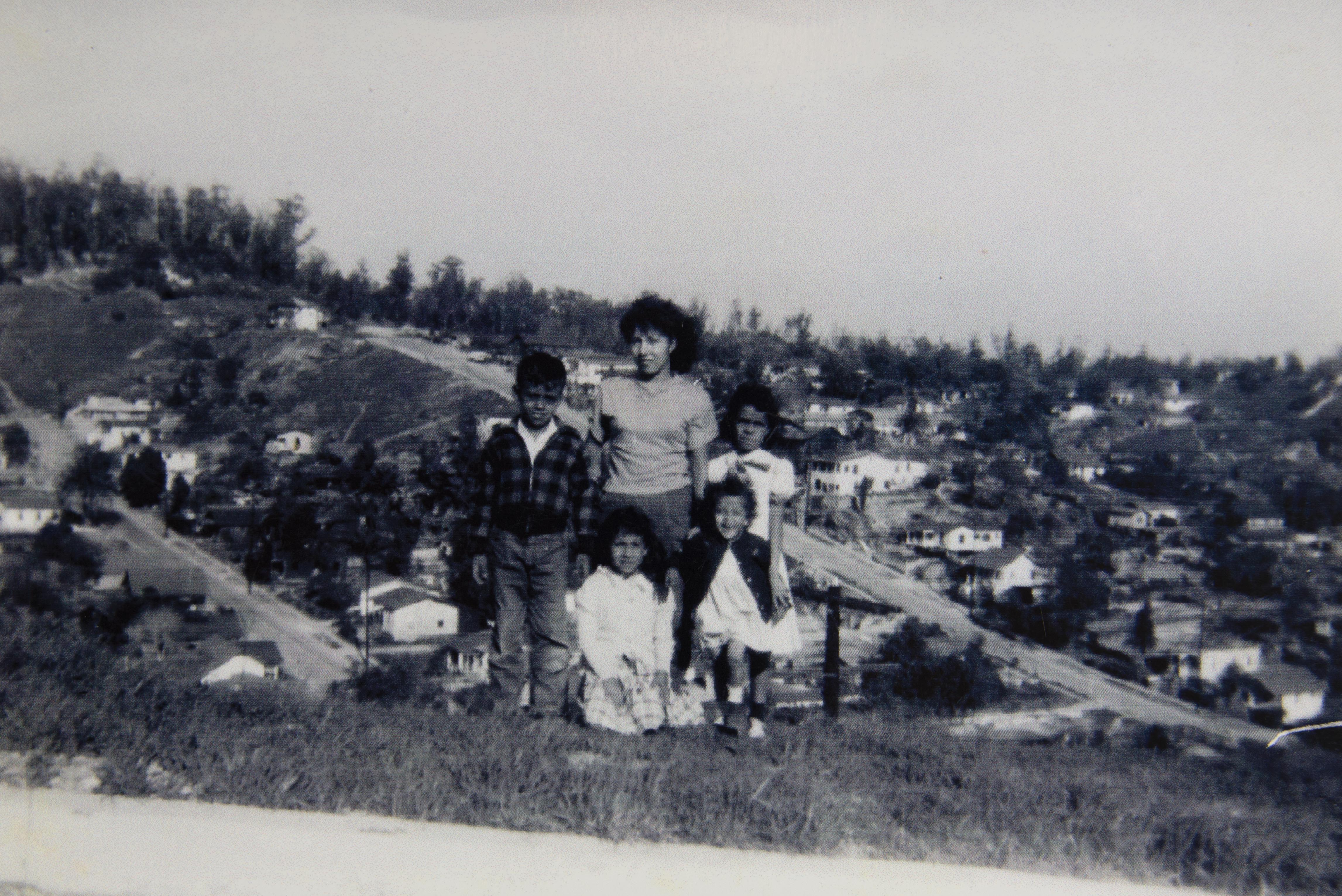 Esther Molano (back center) stands with family members Annie Huitron (back right) and Della Huitron (front right) atop a hill in the Palo Verde neighborhood. The other two children are unidentified.